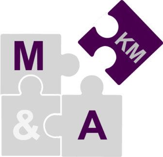 Puzzle pieces that show three puzzle pieces with "M&A" written on them and another puzzle piece completing the puzzle with "KM" written on it, showing how KM is a piece of the M&A puzzle