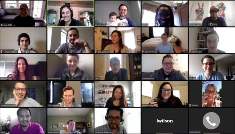 EKers on a video zoom call for a company-wide virtual happy hour. Everyone is smiling.